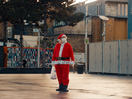 Grumpy Self-Isolating Santa Waves Turkey Leg at Progressive Views in Relatable Christmas Movie 